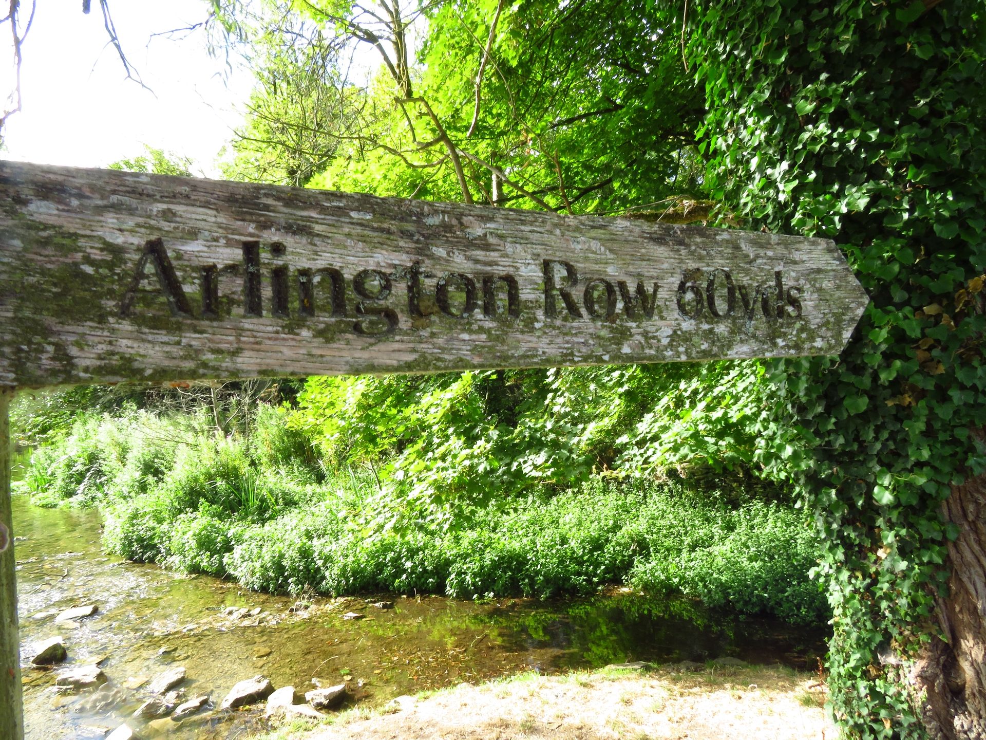 A wooden fingerpost reads 