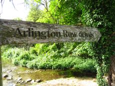 A wooden fingerpost reads 