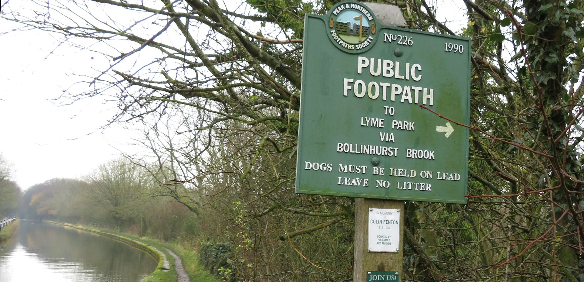 A green cast-iron sign reads 